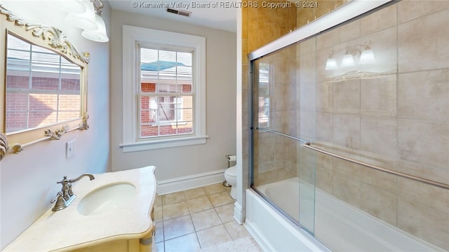 full bathroom featuring tile patterned flooring, vanity, toilet, and shower / bath combination with glass door