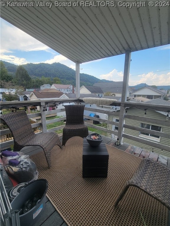 exterior space with a mountain view and a balcony