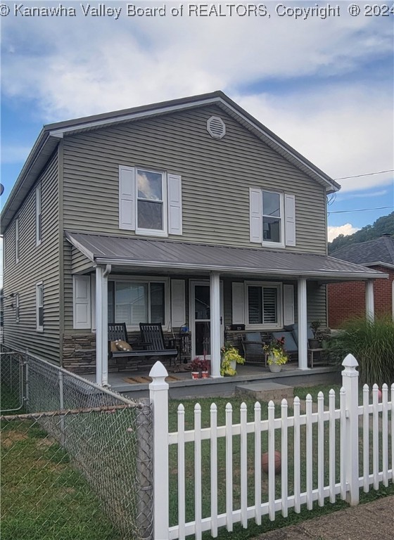 view of front of house with a front yard and a porch