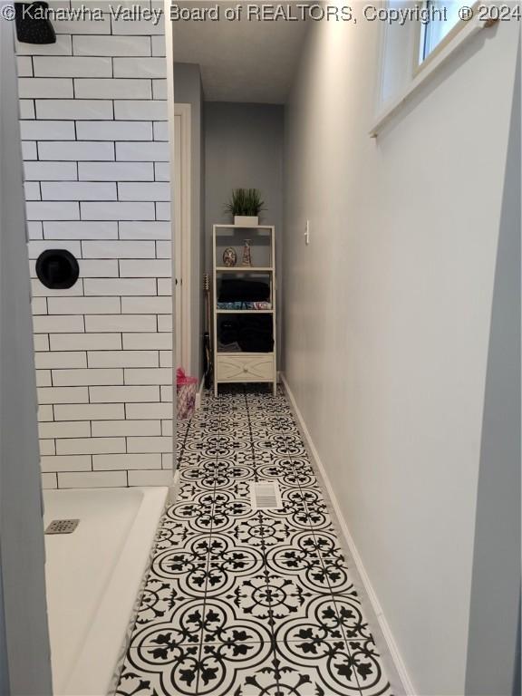 corridor featuring light tile patterned flooring