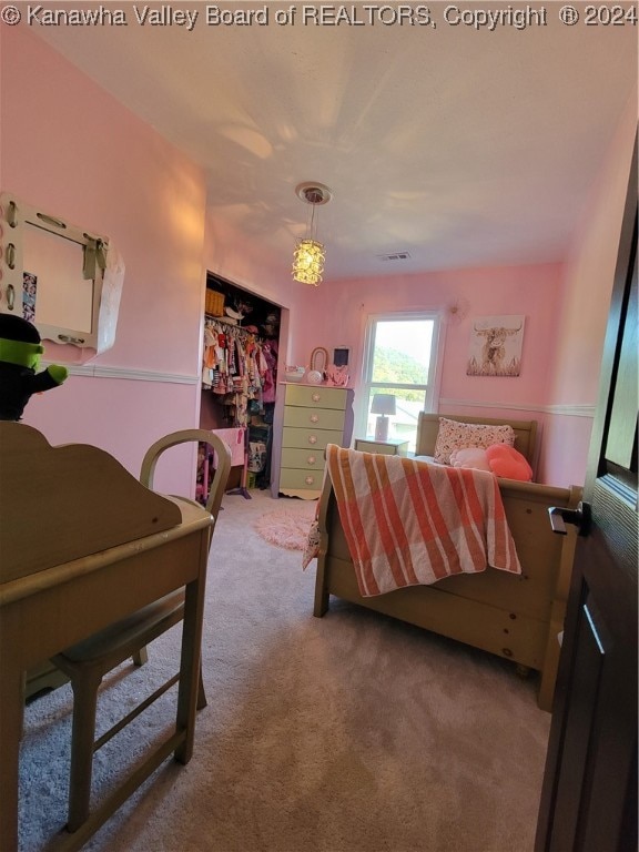 carpeted bedroom with a closet