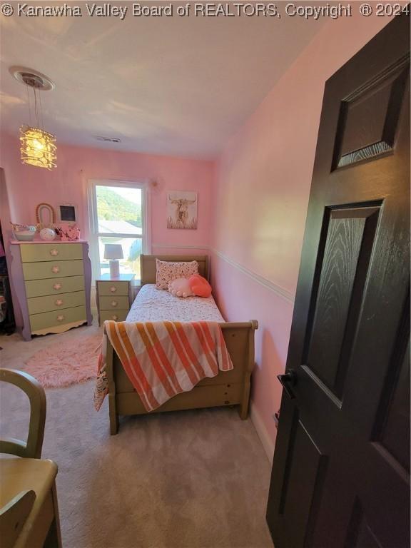 bedroom featuring light colored carpet