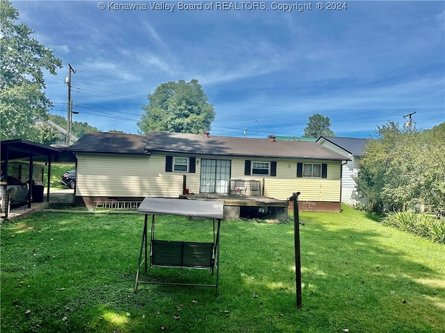 rear view of house featuring a lawn