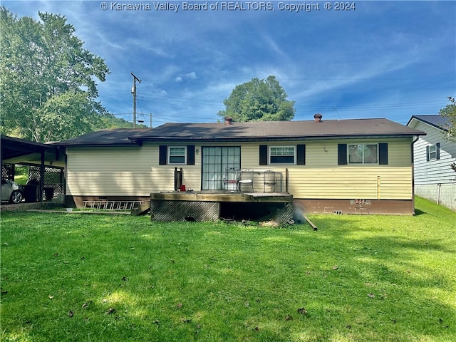 back of property featuring a lawn and a wooden deck