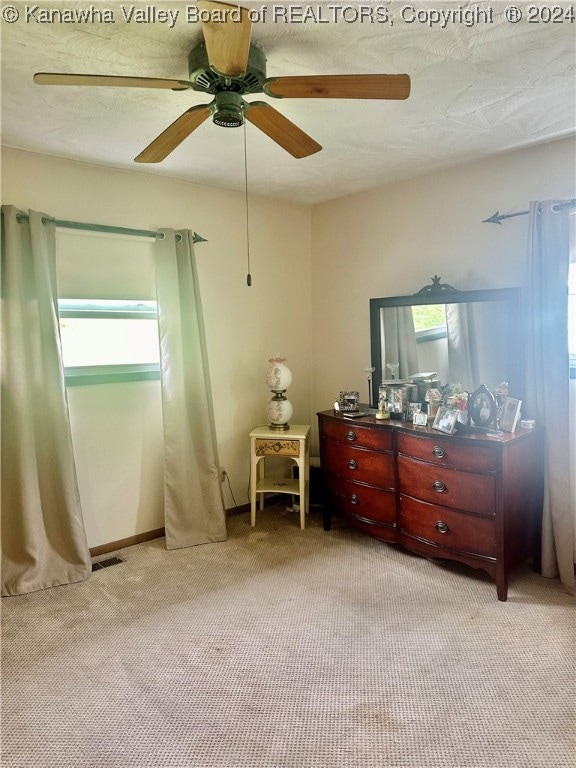 bedroom with light colored carpet and ceiling fan