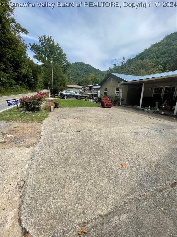 exterior space with a mountain view and a carport