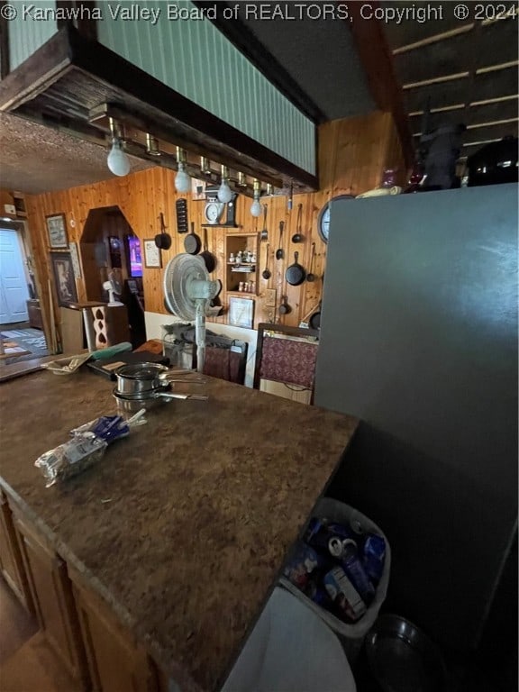 kitchen featuring wood walls