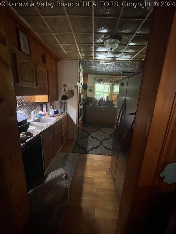 kitchen featuring light wood-type flooring, stainless steel appliances, and sink