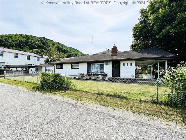 view of front of home featuring a front lawn and a carport