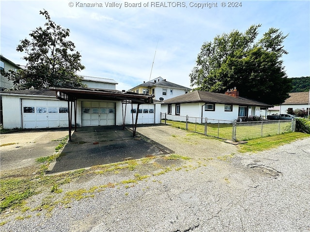 ranch-style home with a garage and a front lawn