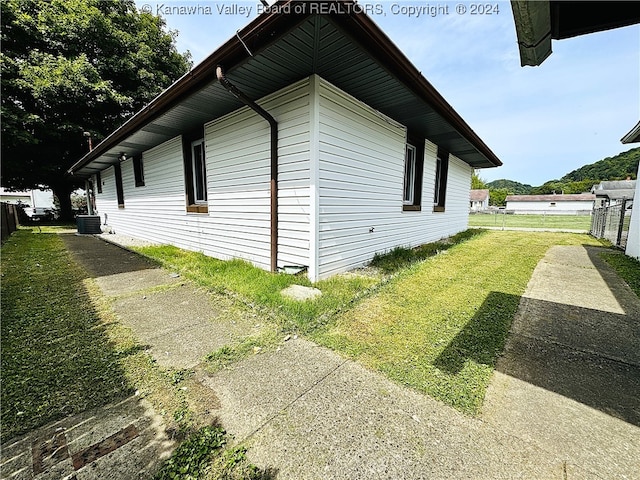 view of property exterior featuring a yard and cooling unit