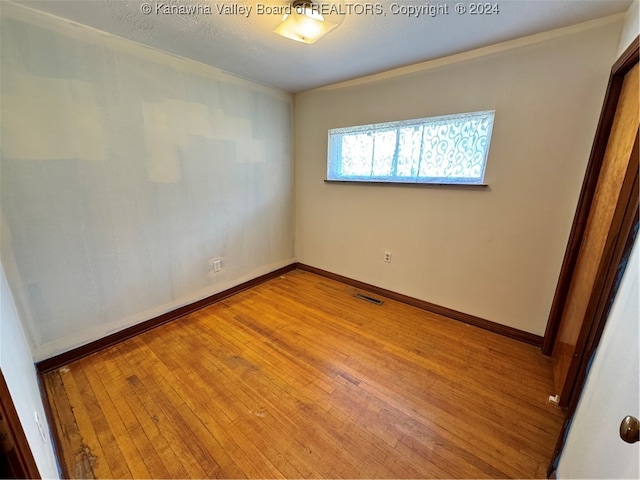 unfurnished room with light hardwood / wood-style floors