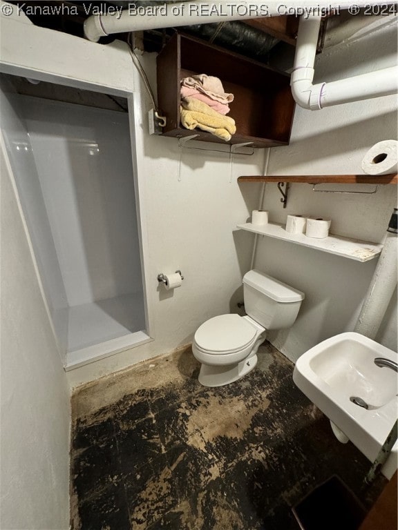 bathroom with a shower, toilet, and sink