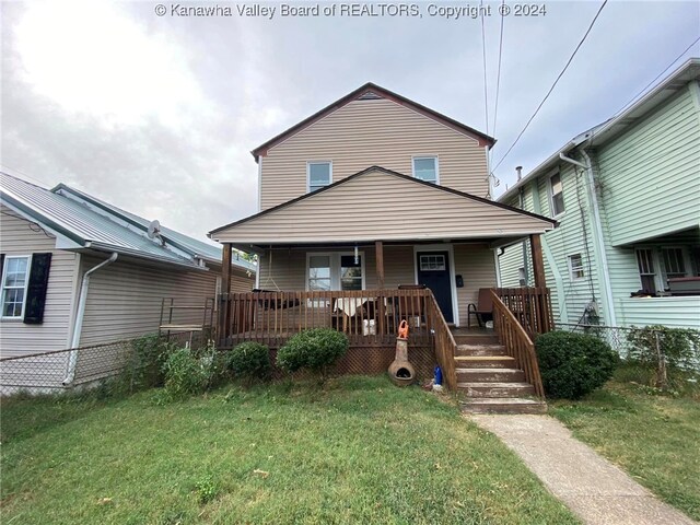 view of front of house with a front yard and a porch