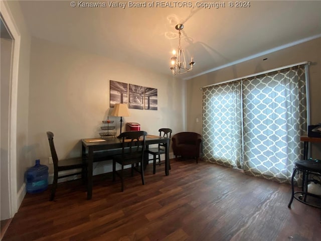 dining space with a notable chandelier and dark hardwood / wood-style floors