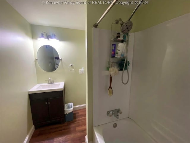 bathroom with vanity, shower / bath combination, and hardwood / wood-style flooring