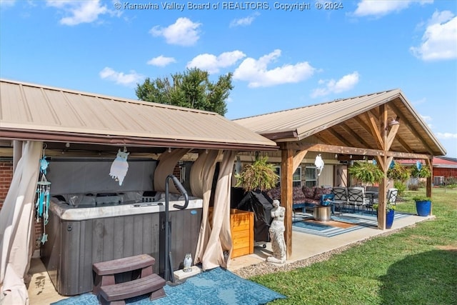 view of property's community with a gazebo, a hot tub, a yard, and a patio area