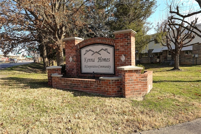 community sign featuring a lawn