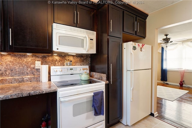 kitchen with light hardwood / wood-style flooring, light stone countertops, white appliances, and dark brown cabinets