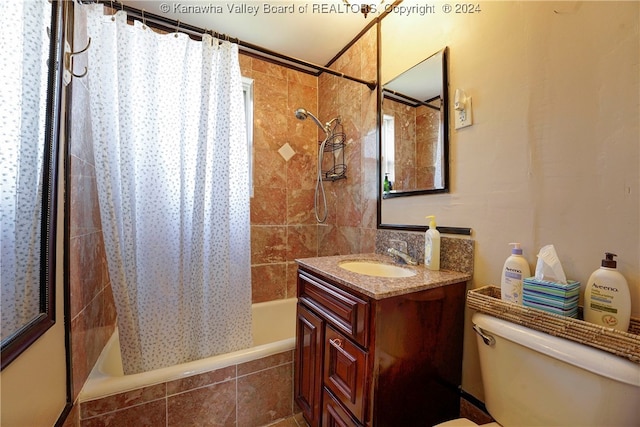 full bathroom featuring vanity, toilet, and shower / tub combo