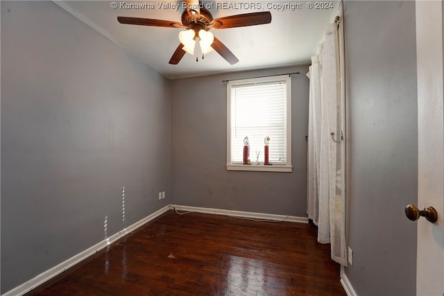 unfurnished room featuring dark wood-type flooring and ceiling fan