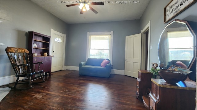 sitting room with ceiling fan and dark hardwood / wood-style flooring