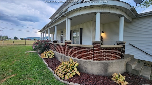 view of home's exterior featuring a yard and covered porch