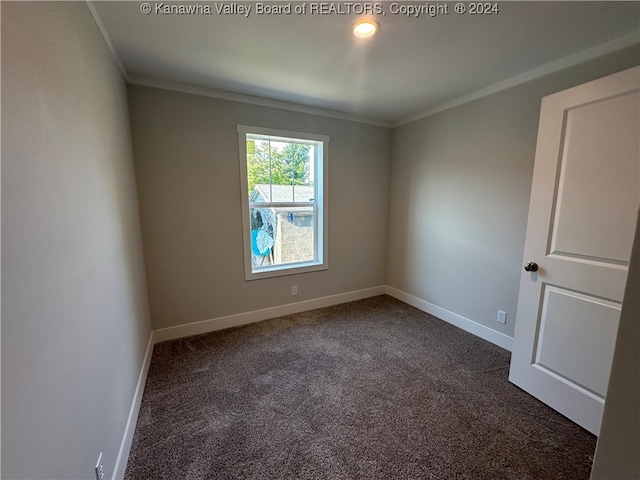 carpeted spare room featuring crown molding