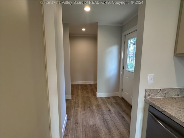 entryway featuring light wood-type flooring and ornamental molding