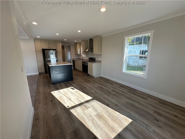 kitchen featuring stainless steel refrigerator, sink, electric stove, wall chimney exhaust hood, and a kitchen island