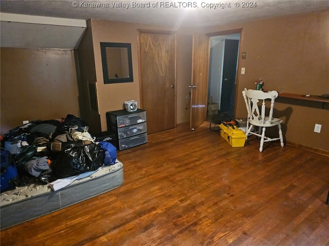 bedroom featuring hardwood / wood-style floors and a textured ceiling