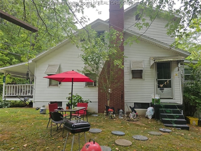 rear view of property with a yard