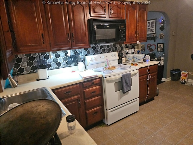 kitchen featuring backsplash and white range with electric cooktop