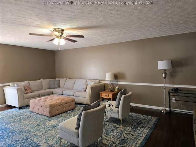 living room featuring a textured ceiling, ceiling fan, and dark hardwood / wood-style flooring