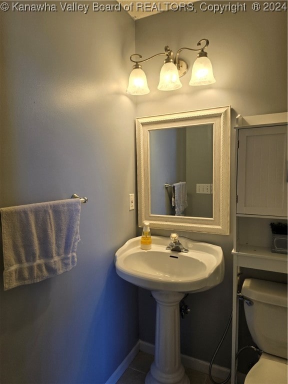 bathroom with toilet and tile patterned flooring