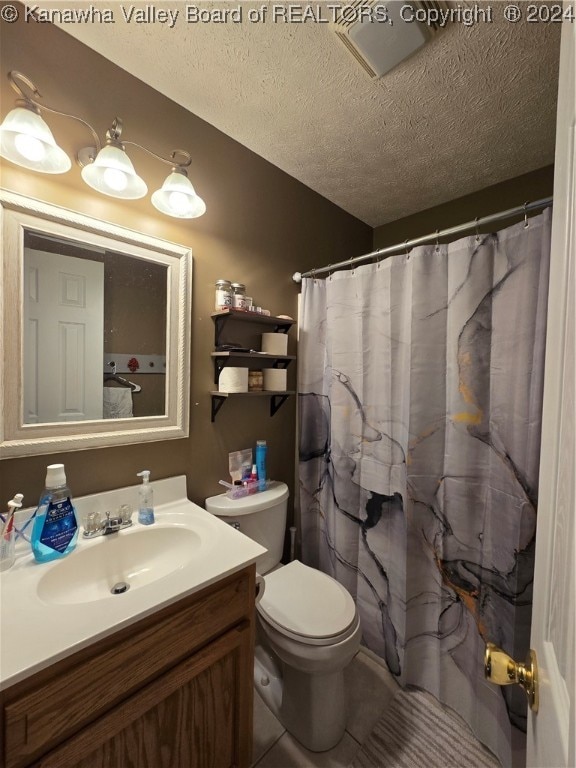 bathroom featuring walk in shower, toilet, a textured ceiling, and vanity