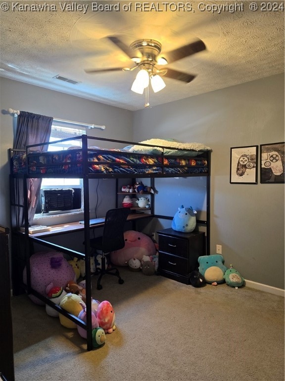 bedroom with ceiling fan, carpet, and a textured ceiling