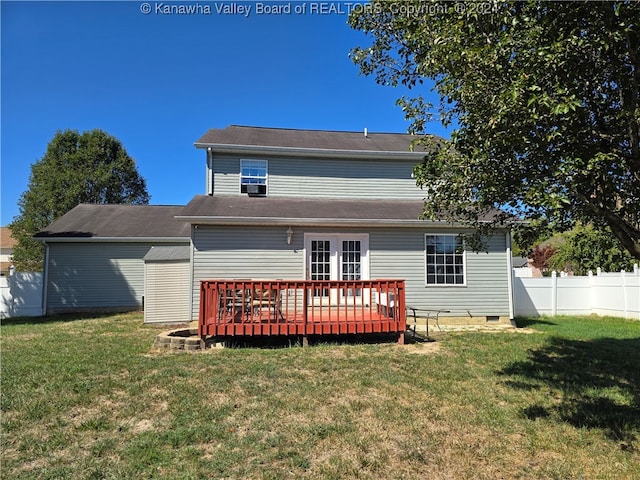 back of house featuring a deck and a lawn