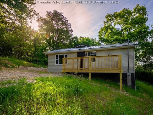 back house at dusk with a deck