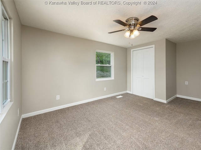 unfurnished bedroom featuring a closet, ceiling fan, and carpet