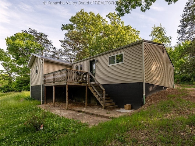 back of house featuring a deck