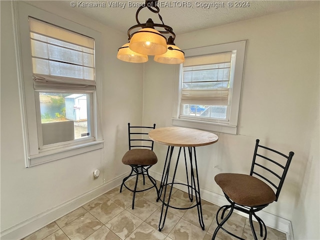 dining area featuring a textured ceiling