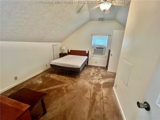 bedroom with a textured ceiling, lofted ceiling, ceiling fan, and carpet flooring