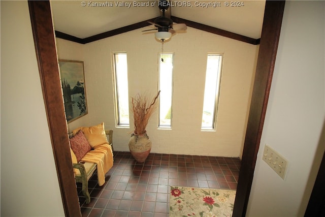 interior space with ceiling fan, plenty of natural light, and lofted ceiling with beams