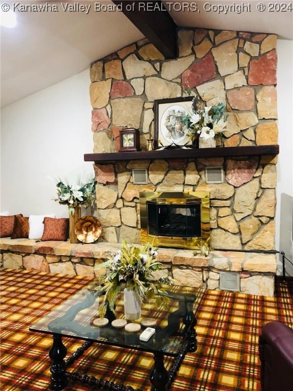 unfurnished living room with lofted ceiling and a stone fireplace