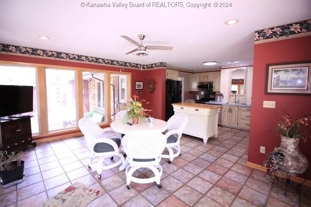 dining space featuring ceiling fan and light tile patterned floors