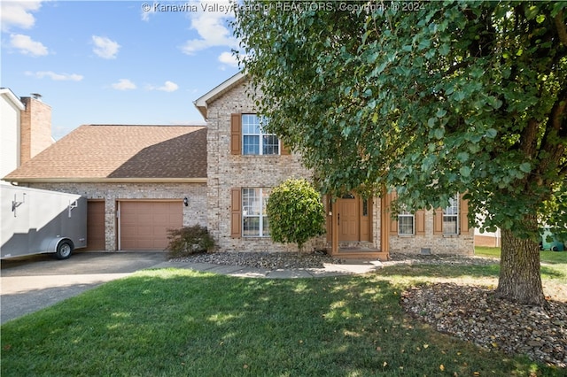 view of front of home featuring a garage and a front lawn