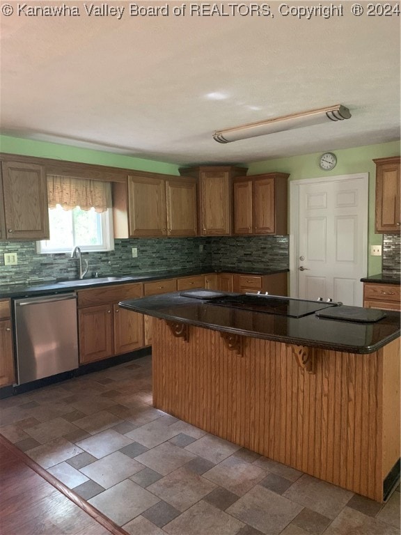 kitchen featuring a kitchen breakfast bar, a center island, and stainless steel dishwasher