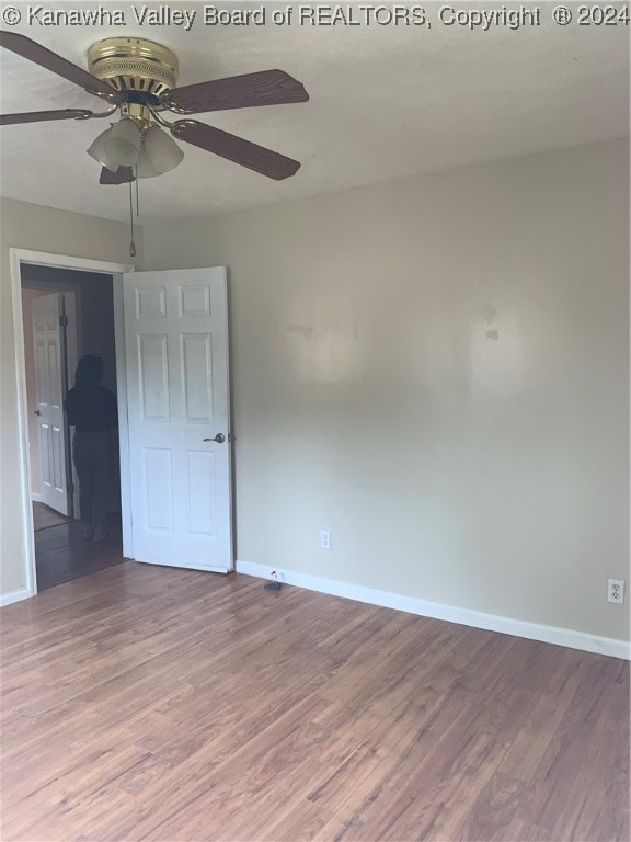 spare room featuring ceiling fan and hardwood / wood-style flooring