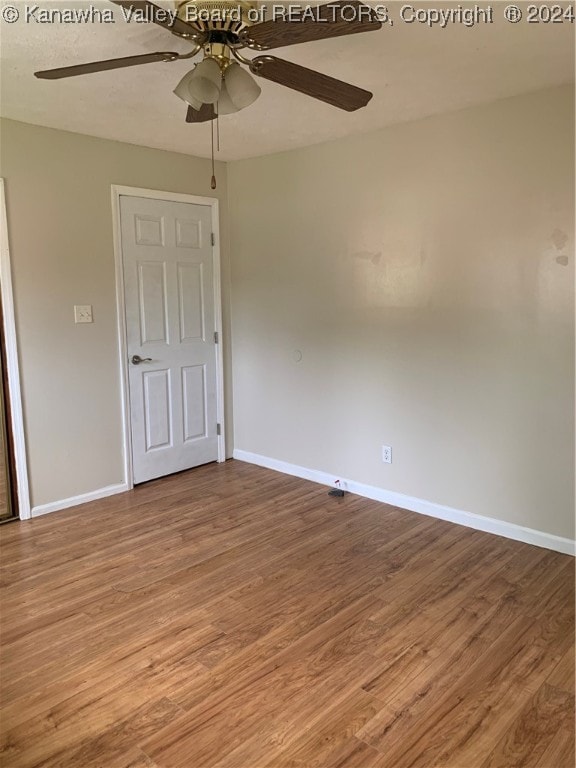 spare room featuring ceiling fan and hardwood / wood-style flooring